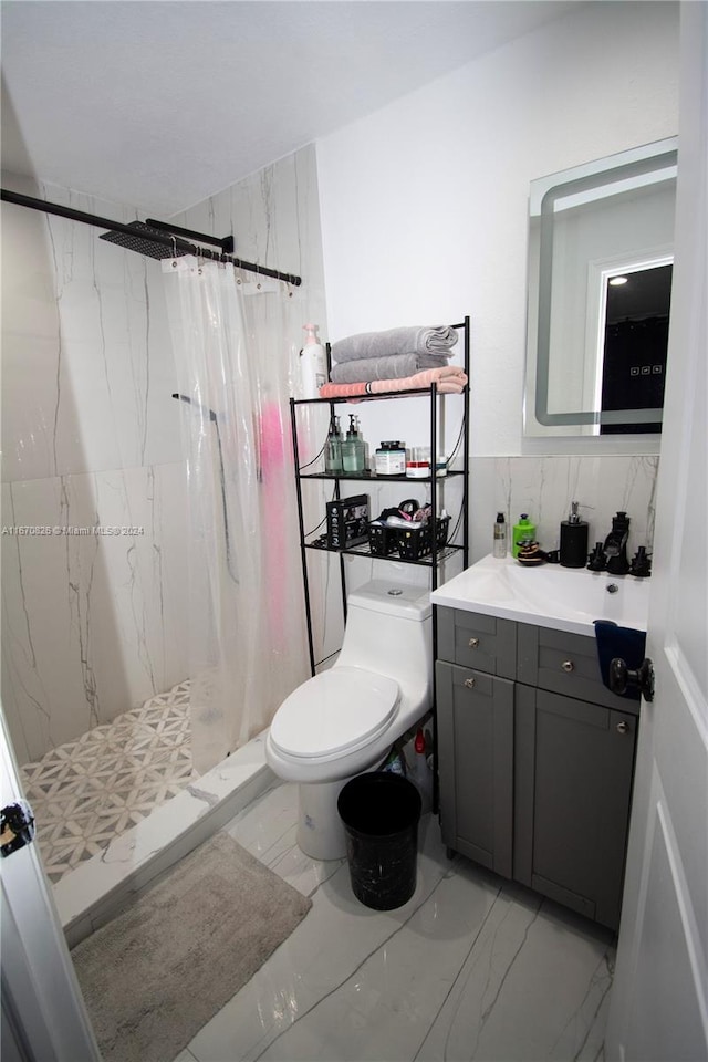 bathroom with walk in shower, vanity, and toilet