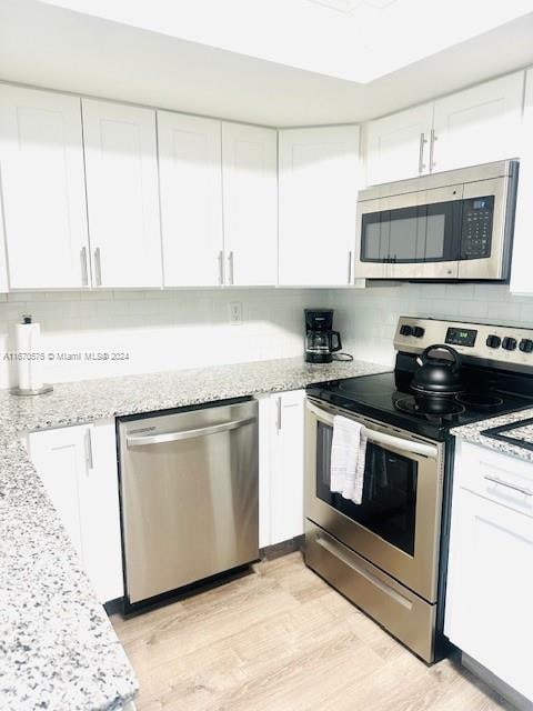 kitchen featuring white cabinetry and stainless steel appliances