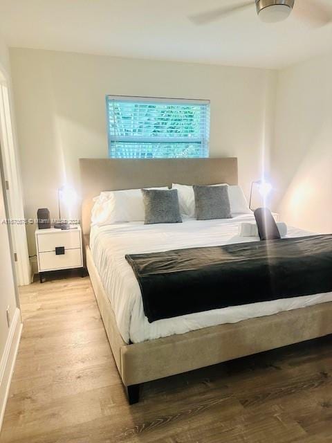 bedroom featuring ceiling fan and light hardwood / wood-style flooring