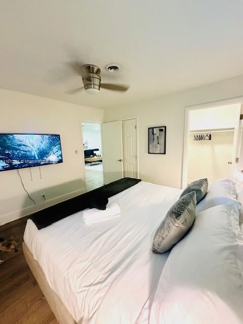 bedroom with ceiling fan, a closet, and hardwood / wood-style flooring