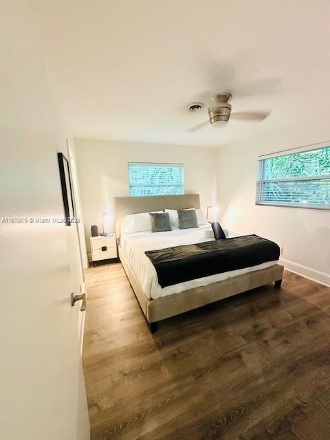 bedroom with wood-type flooring and ceiling fan