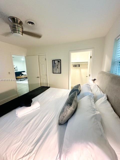 bedroom with ceiling fan and a closet