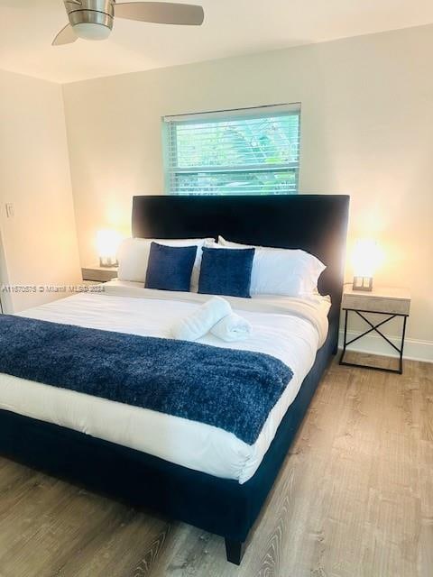 bedroom featuring hardwood / wood-style flooring and ceiling fan