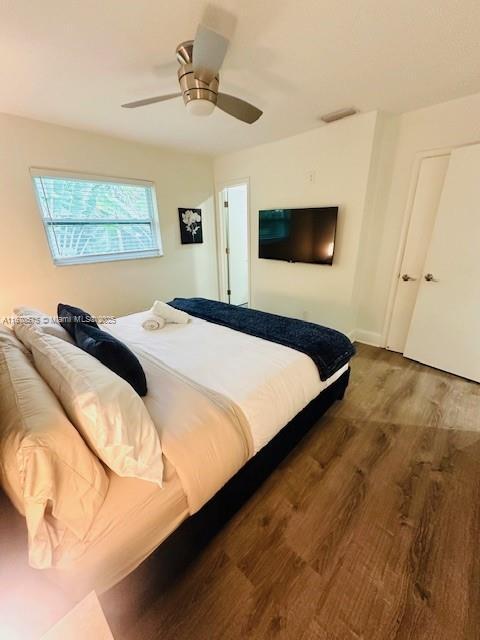 bedroom with ceiling fan and hardwood / wood-style floors