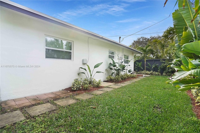 view of home's exterior featuring a lawn