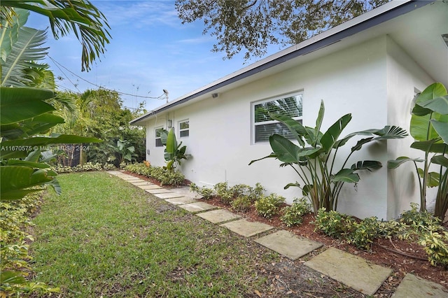 view of home's exterior with a yard