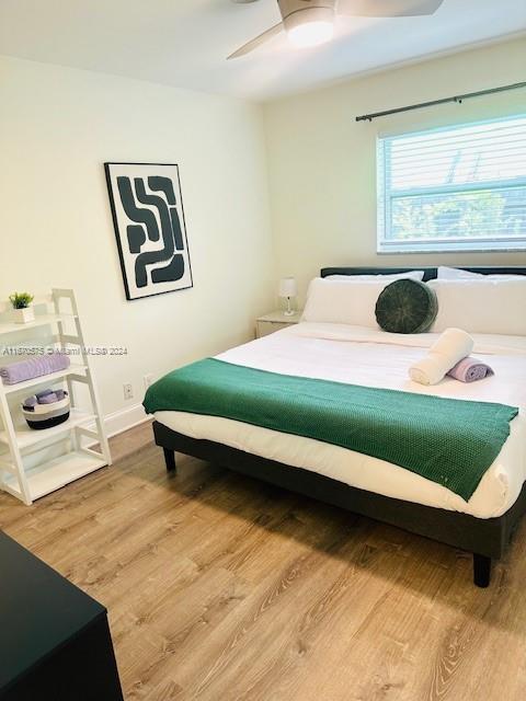 bedroom with ceiling fan and wood-type flooring