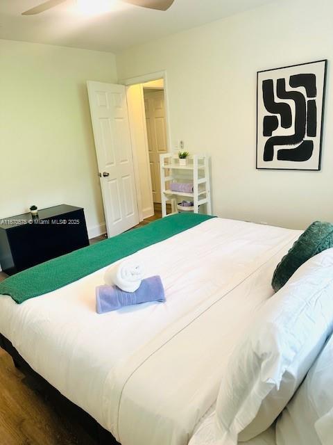 bedroom with wood-type flooring and ceiling fan