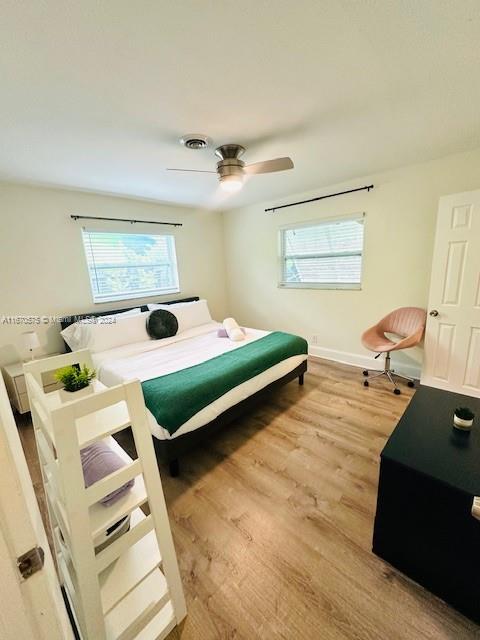 bedroom with light wood-type flooring and ceiling fan