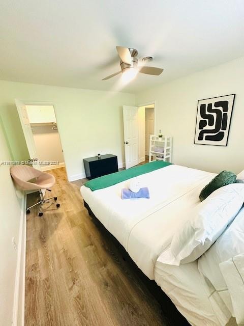 bedroom with hardwood / wood-style floors and ceiling fan