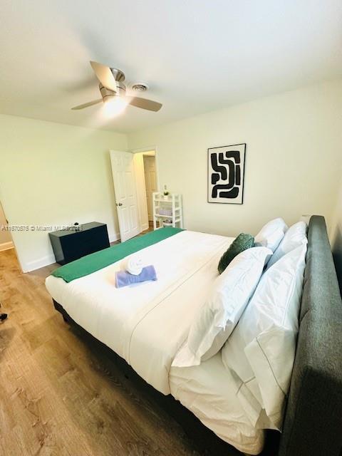 bedroom with hardwood / wood-style flooring and ceiling fan