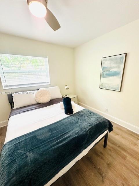 bedroom featuring hardwood / wood-style flooring and ceiling fan