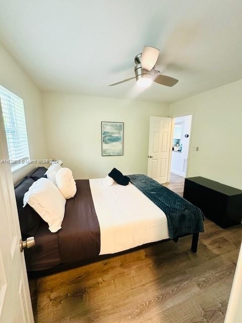 bedroom with hardwood / wood-style floors and ceiling fan