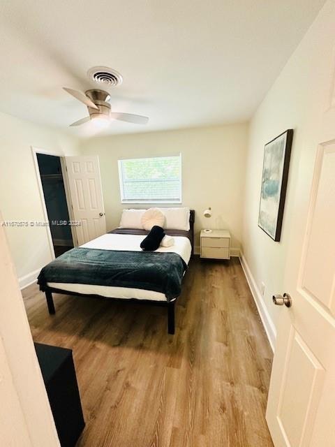 bedroom with ceiling fan and light wood-type flooring