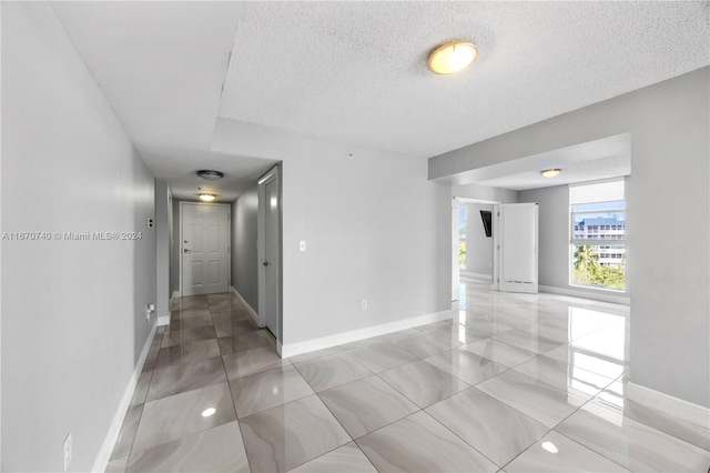 empty room with a textured ceiling