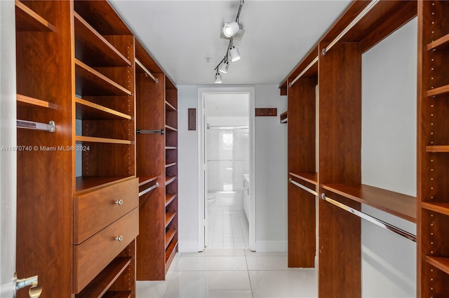 spacious closet featuring light tile patterned floors