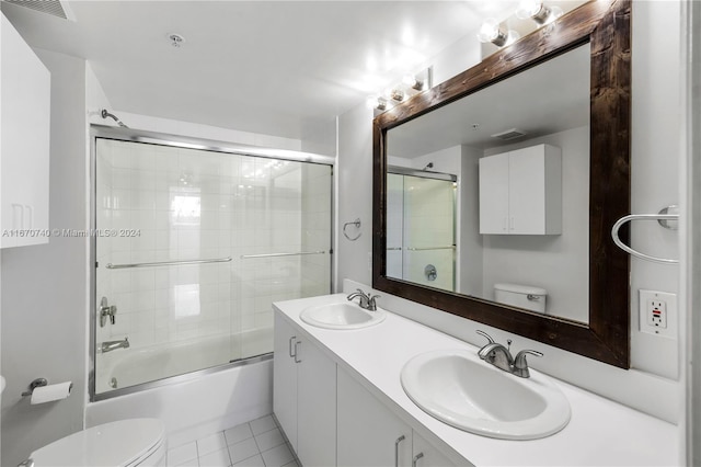 full bathroom with vanity, tile patterned flooring, toilet, and combined bath / shower with glass door