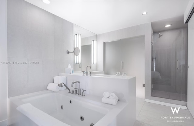 bathroom featuring independent shower and bath and tile patterned flooring