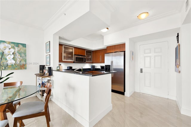 kitchen featuring ornamental molding, sink, appliances with stainless steel finishes, and kitchen peninsula