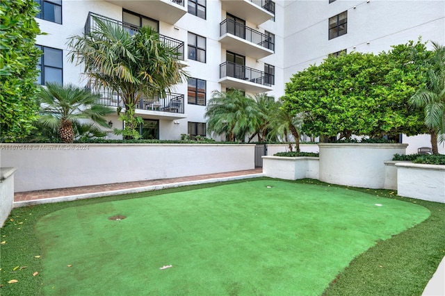 view of yard with a balcony