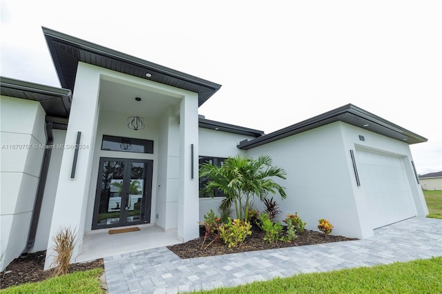 doorway to property with a garage