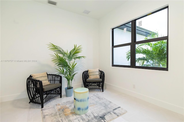 sitting room featuring a wealth of natural light and light tile patterned floors