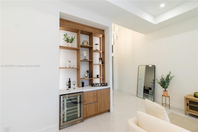 bar with wine cooler and light tile patterned floors