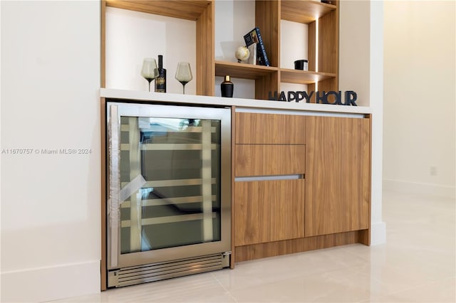 bar with wine cooler and light tile patterned floors