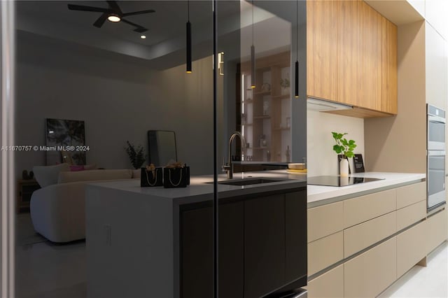 kitchen with stainless steel double oven, ceiling fan, sink, and black electric stovetop