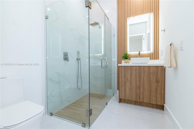 bathroom with tile patterned floors, toilet, walk in shower, and vanity