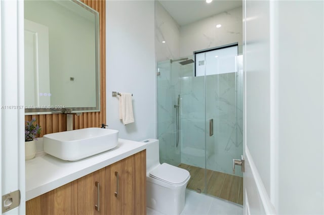 bathroom with tile patterned flooring, an enclosed shower, vanity, and toilet