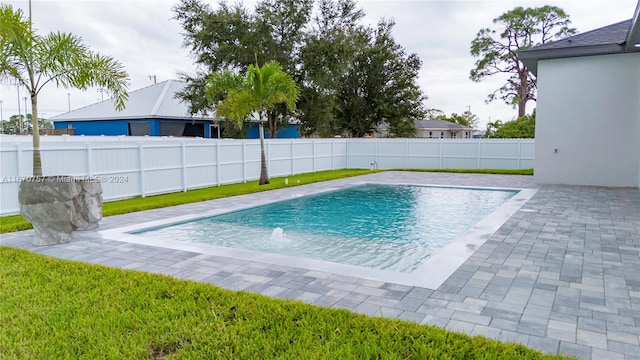 view of pool with a patio area and pool water feature