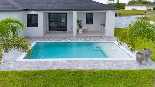 view of pool featuring a yard and a patio area