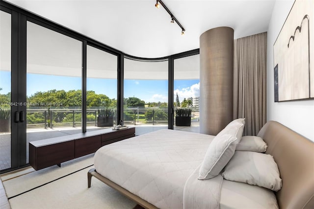 bedroom with expansive windows and track lighting