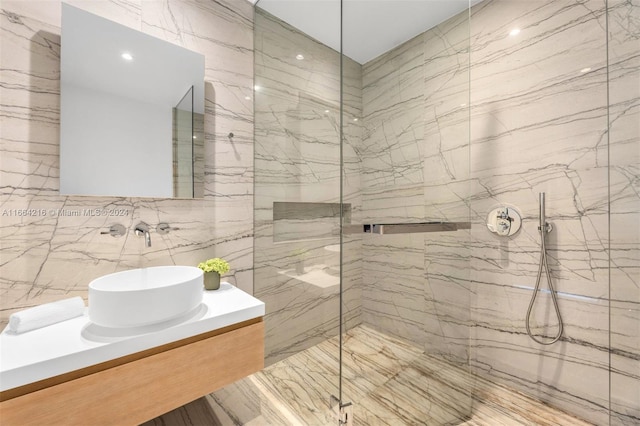 bathroom featuring tile walls, vanity, and tiled shower