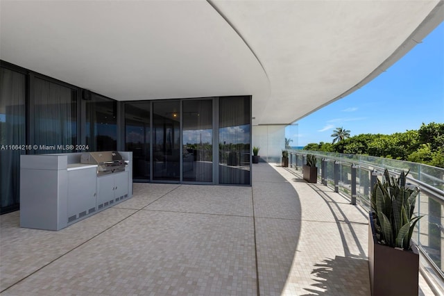 view of patio featuring grilling area and a balcony