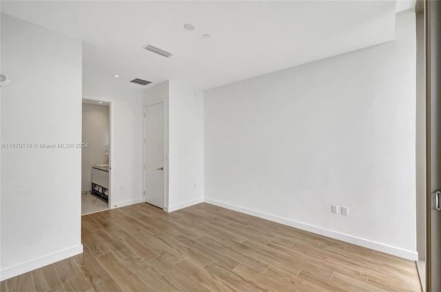 spare room with light hardwood / wood-style flooring