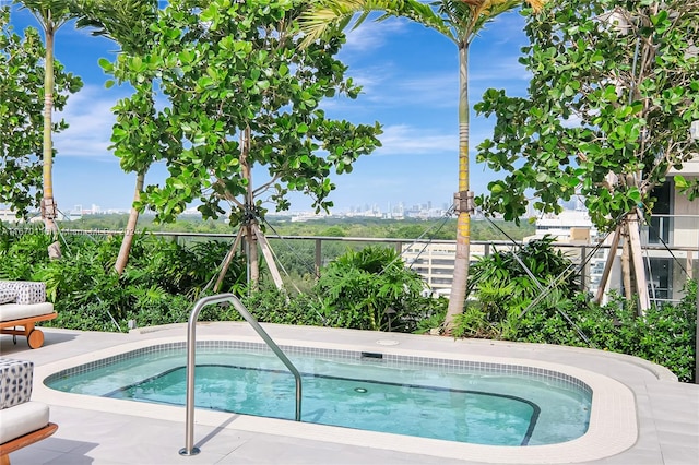 view of swimming pool with an in ground hot tub