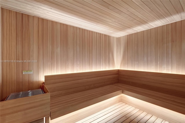 view of sauna / steam room with wood-type flooring and wooden ceiling