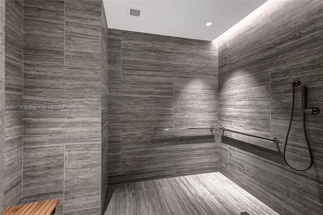 bathroom with tiled shower