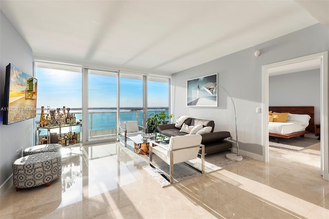 living room with a water view and expansive windows