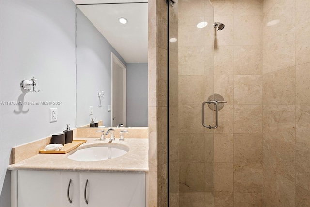 bathroom with walk in shower and vanity