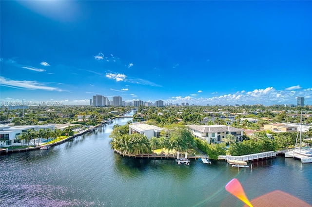 drone / aerial view featuring a view of city and a water view