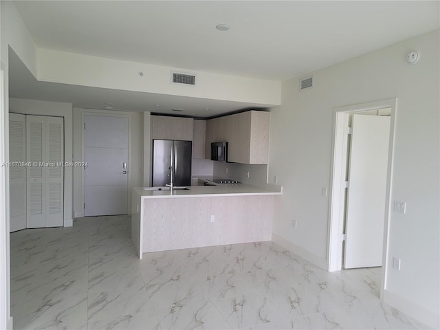 kitchen with kitchen peninsula, sink, and stainless steel appliances