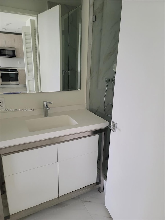 bathroom featuring vanity and an enclosed shower