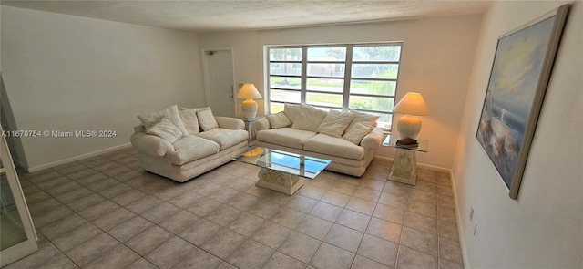 living room with a textured ceiling and light tile patterned floors