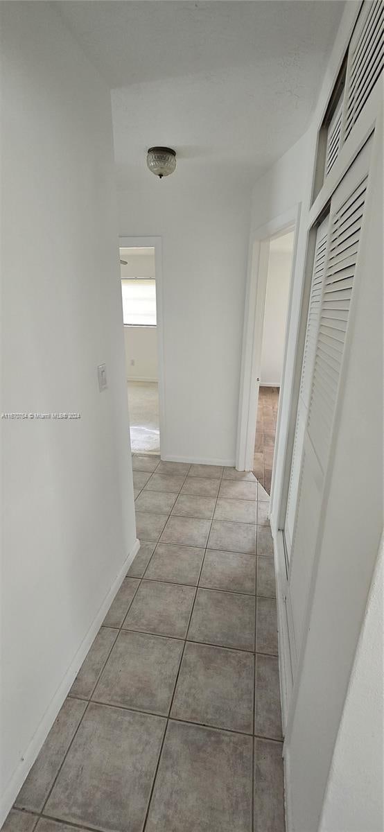 hallway featuring light tile patterned floors