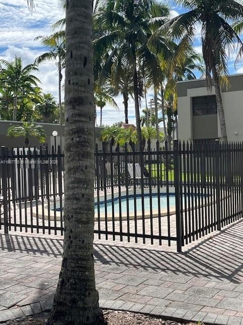 view of gate featuring a community pool