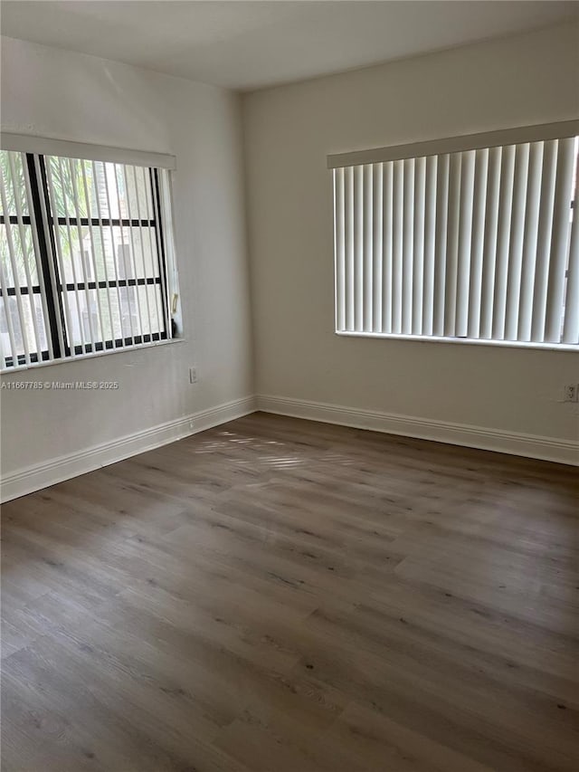 empty room featuring dark hardwood / wood-style flooring