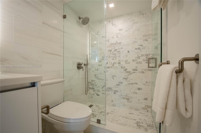 bathroom featuring vanity, toilet, and an enclosed shower